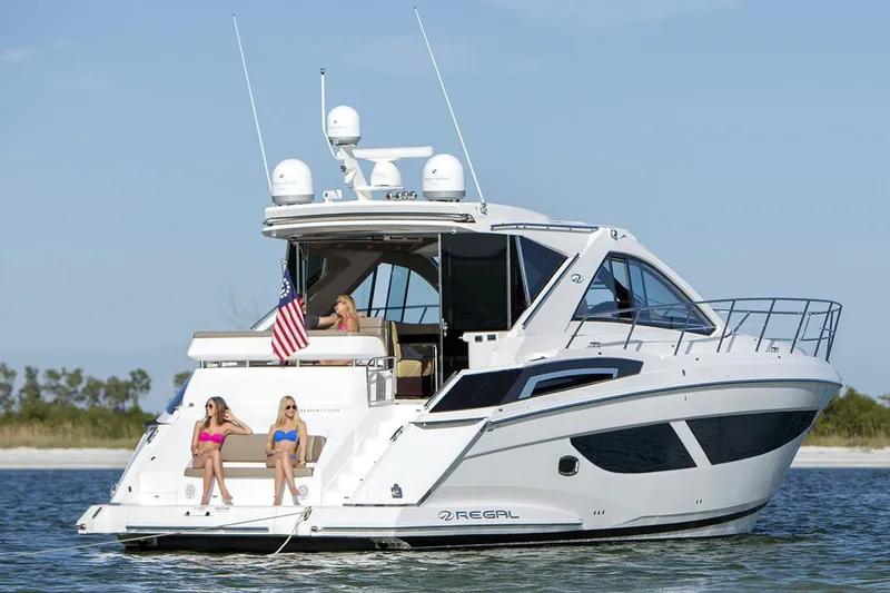 Slide: The Image of Manufacturer Provided Image: 2018 Regal 53 Sport Coupe yacht on water with people relaxing. - 3