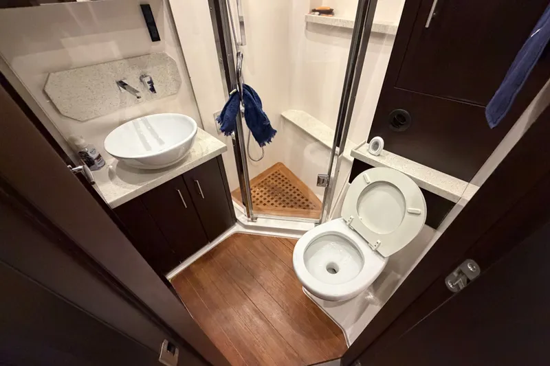 Slide: The Image of Luxurious bathroom in 2018 Regal 53 Sport Coupe yacht with modern fixtures and wooden flooring. - 122