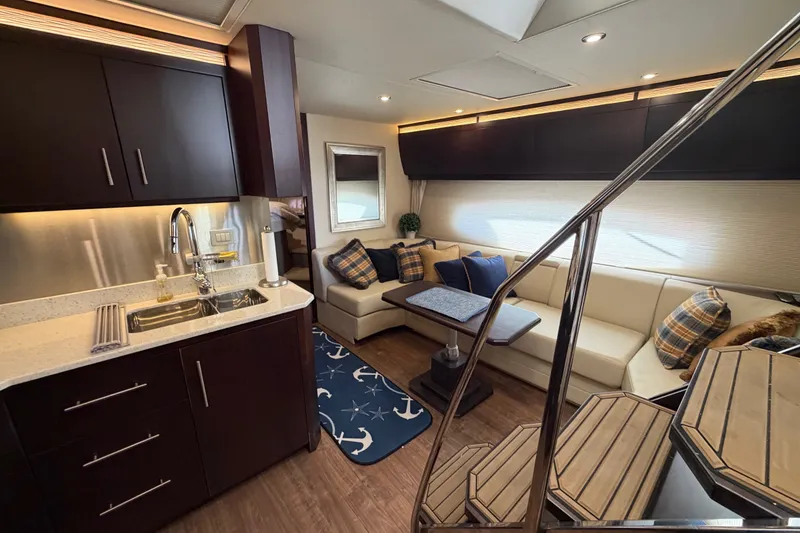 Slide: The Image of Luxurious interior of 2018 Regal 53 Sport Coupe yacht with modern kitchen and cozy seating area. - 97