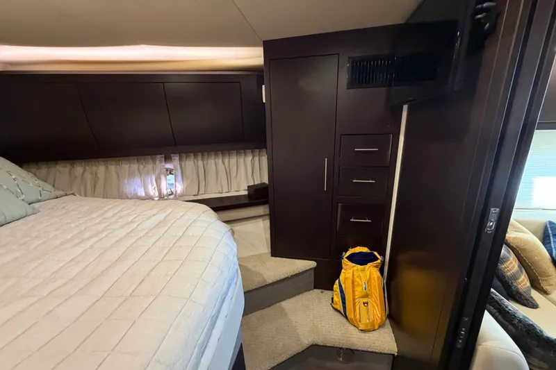 Slide: The Image of Luxurious cabin interior of 2018 Regal 53 Sport Coupe with bed and storage. - 119