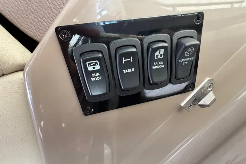Slide: The Image of Control panel with switches for sunroof, table, salon window, and courtesy lights on a 2018 Regal 53 Sport Coupe. - 88