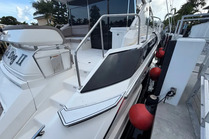 Slide: The Image of 2018 Regal 53 Sport Coupe yacht docked with red fenders, sleek design. - 24