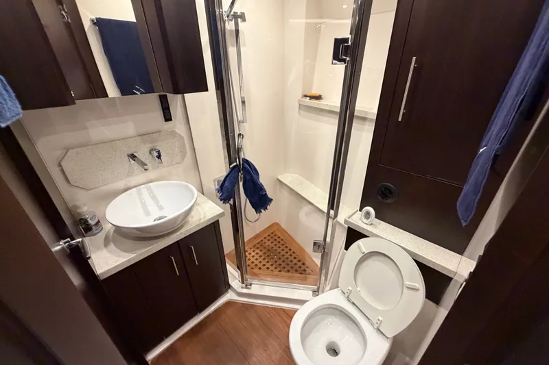 Slide: The Image of Luxurious bathroom in 2018 Regal 53 Sport Coupe yacht with modern fixtures and wooden accents. - 123