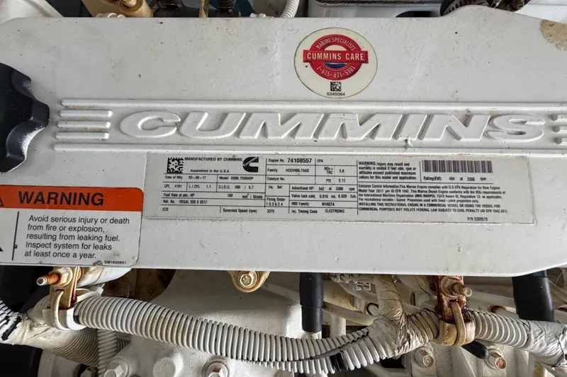 Slide: The Image of Cummins engine in 2018 Regal 53 Sport Coupe with safety warning label visible. - 60