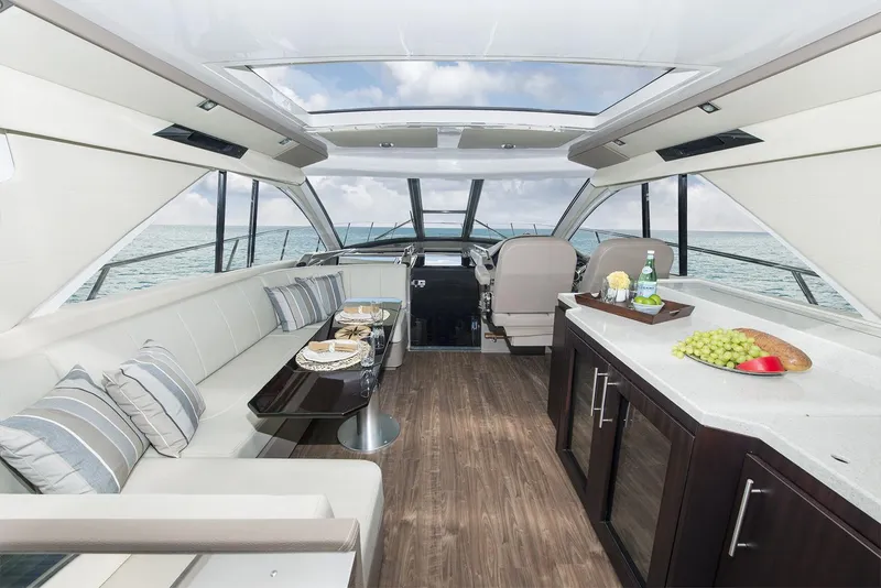 Slide: The Image of Manufacturer Provided Image: 2018 Regal 53 Sport Coupe yacht interior with modern seating and dining area. - 126