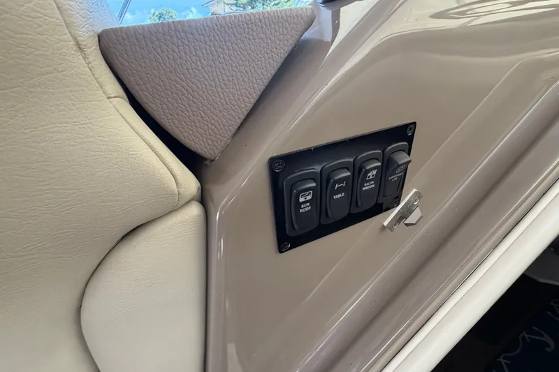 Slide: The Image of 2018 Regal 53 Sport Coupe interior control panel with switches for sunroof and windows. - 87