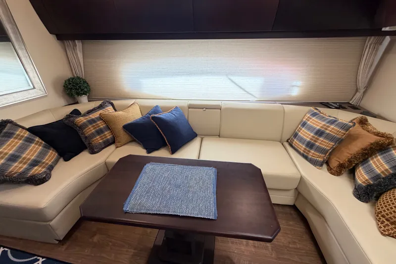 Slide: The Image of Luxurious interior of 2018 Regal 53 Sport Coupe with plush seating and decorative pillows. - 112