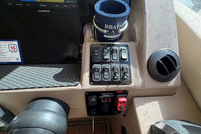 Slide: The Image of Control panel of a 2018 Regal 53 Sport Coupe with switches and a Garmin display. - 78