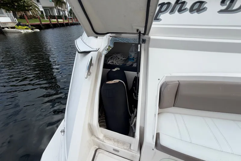 Slide: The Image of Open storage compartment on 2018 Regal 53 Sport Coupe yacht by the water. - 48