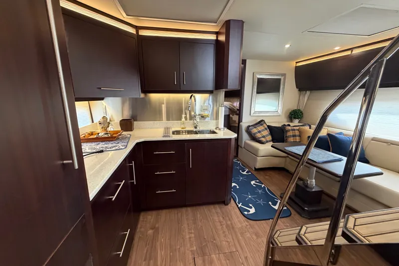 Slide: The Image of Luxurious interior of 2018 Regal 53 Sport Coupe yacht with modern kitchen and seating area. - 111