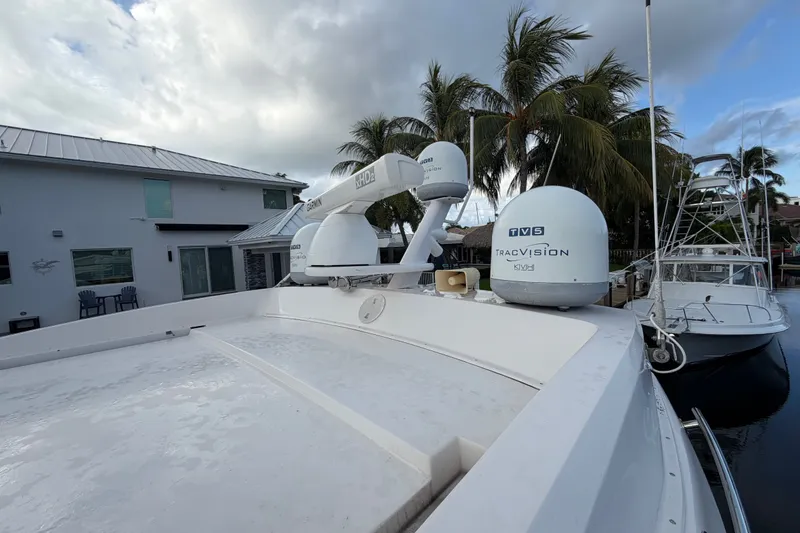 Slide: The Image of 2018 Regal 53 Sport Coupe yacht with advanced navigation equipment docked near palm trees. - 39