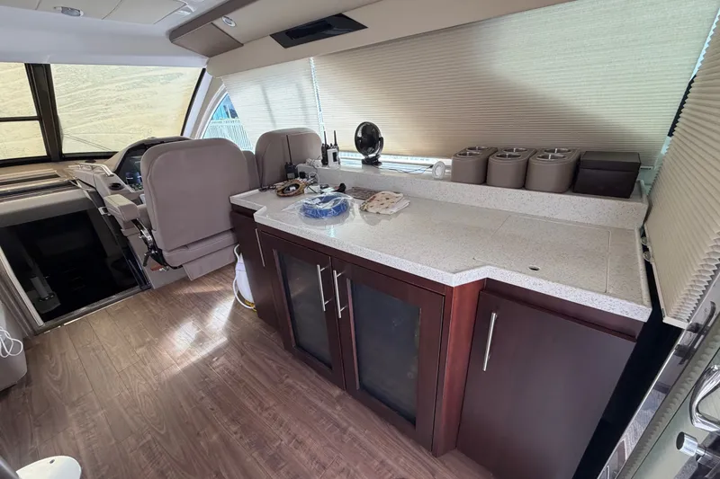 Slide: The Image of Interior of 2018 Regal 53 Sport Coupe with modern kitchen and helm area. - 71