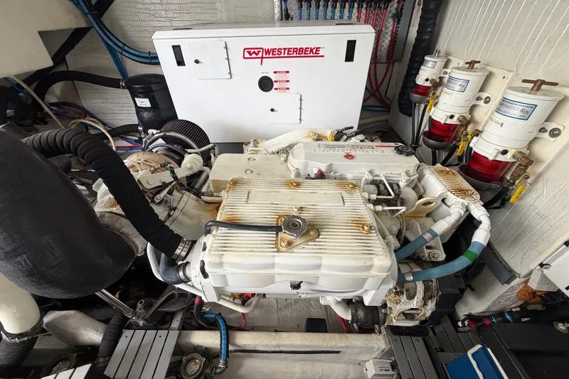 Slide: The Image of Engine room of a 2018 Regal 53 Sport Coupe with Westerbeke generator. - 57