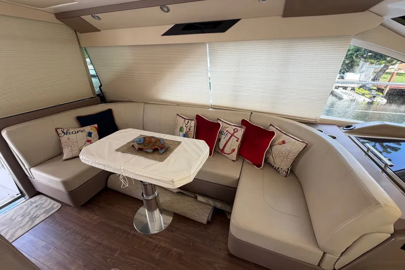 Slide: The Image of Luxurious interior of 2018 Regal 53 Sport Coupe with elegant seating and nautical-themed pillows. - 82