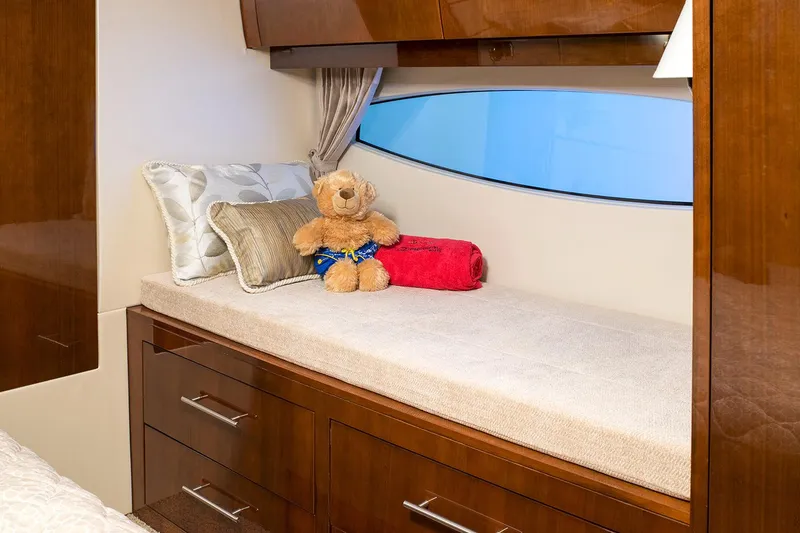 Slide: The Image of Manufacturer Provided Image: 2018 Regal 53 Sport Coupe interior cabin with plush bedding and teddy bear. - 129