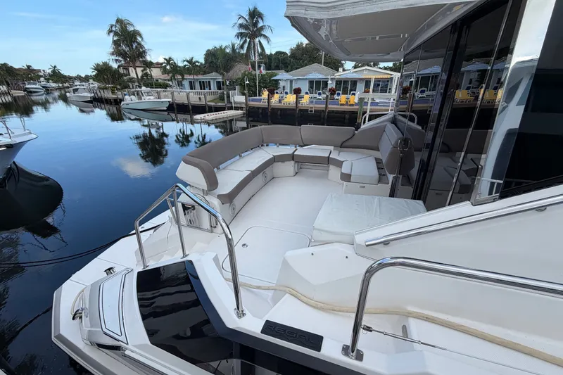 Slide: The Image of Luxurious 2018 Regal 53 Sport Coupe yacht with spacious deck and waterfront view. - 26