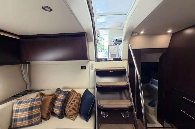 Slide: The Image of Luxurious interior of 2018 Regal 53 Sport Coupe yacht with plush seating and elegant staircase. - 95