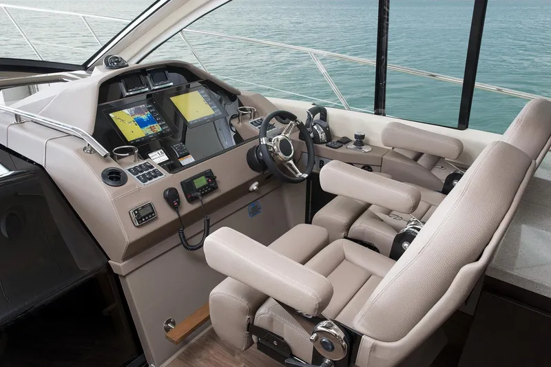 Slide: The Image of Manufacturer Provided Image: 2018 Regal 53 Sport Coupe helm with dual seats and advanced navigation system. - 125