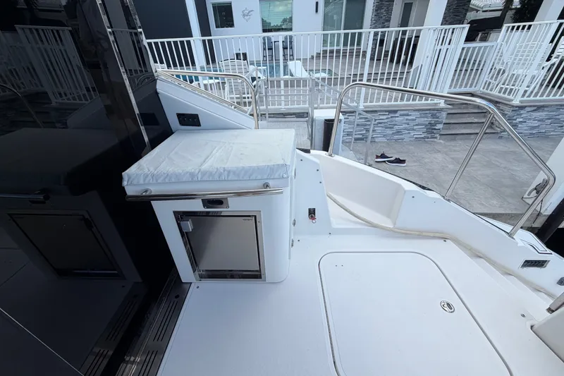 Slide: The Image of 2018 Regal 53 Sport Coupe yacht deck with stainless steel railings and storage compartment. - 30