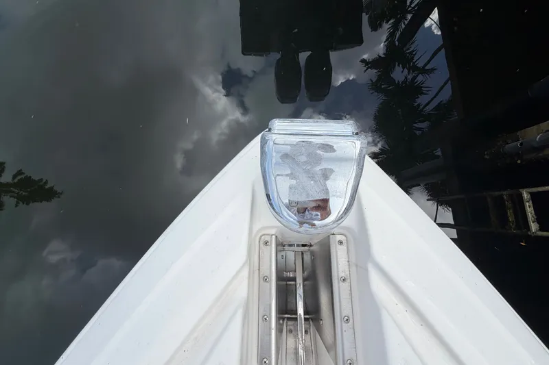 Slide: The Image of Bow of 2018 Regal 53 Sport Coupe reflecting on water surface. - 45