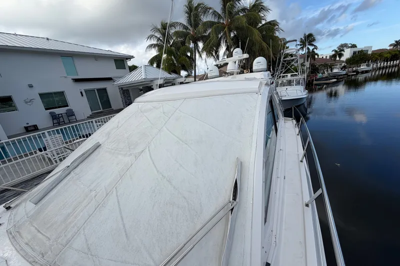 Slide: The Image of 2018 Regal 53 Sport Coupe yacht docked near waterfront homes and palm trees. - 40