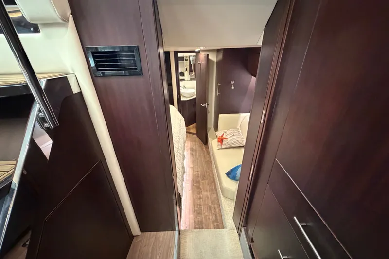 Slide: The Image of Interior of 2018 Regal 53 Sport Coupe yacht with modern wood finishes and seating area. - 98
