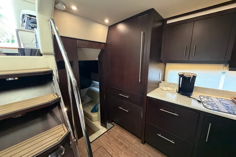 Slide: The Image of Interior of 2018 Regal 53 Sport Coupe yacht with modern kitchen and stairs. - 96