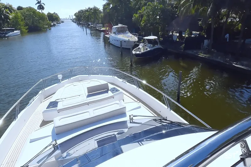 Slide: The Image of The image shows the deck of a 2026 Galeon 560 Fly, situated on a calm waterway. - 40