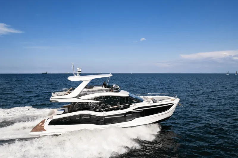Slide: The Image of 2026 Galeon 560 Fly cruising on open sea, sleek design, two decks, modern interior. - 10