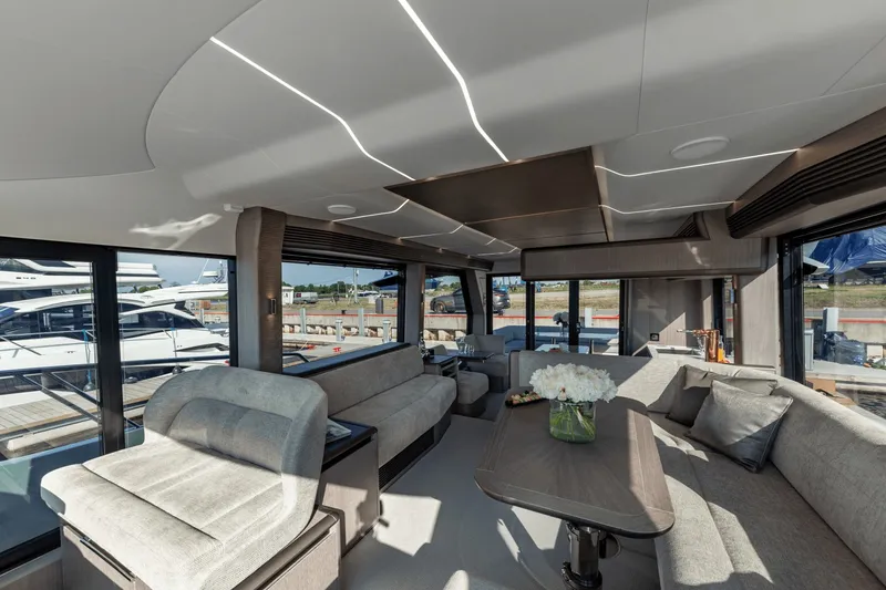 Slide: The Image of Interior of the 2026 Galeon 560 Fly with sleek seating and large windows. - 19
