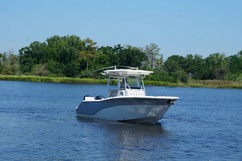 The Image of 2020 Sea Fox 266 Commander boat cruising on a serene lake with lush greenery. - 1