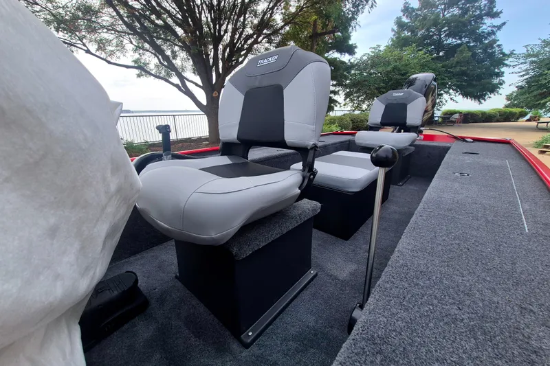 Slide: The Image of 2027 Tracker Panfish 17 boat interior with comfortable seating and scenic lake view. - 14