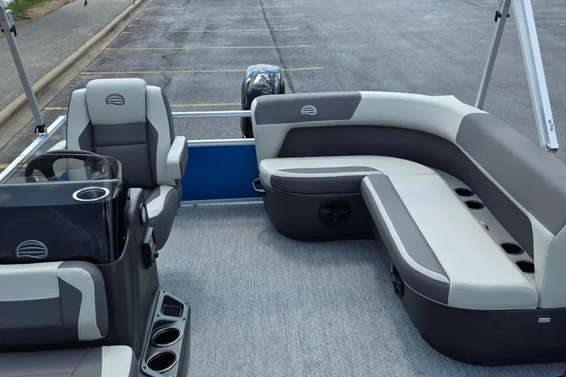 Slide: The Image of 2027 Sun Tracker Bass Buggy 16 XL Select pontoon boat interior with gray seating and steering console. - 14