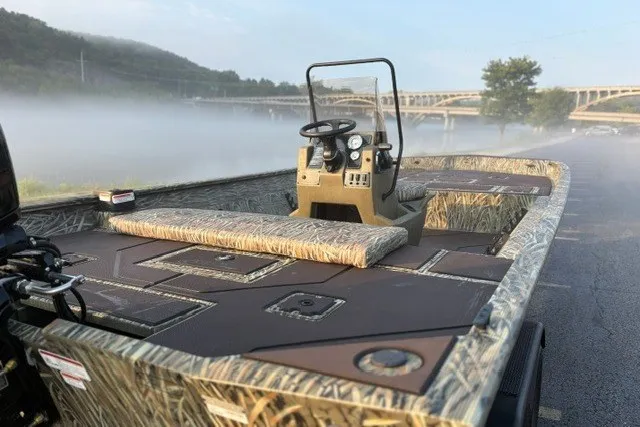 Slide: The Image of 2027 Tracker Grizzly 2072 CC boat with camouflage design on a misty river. - 15