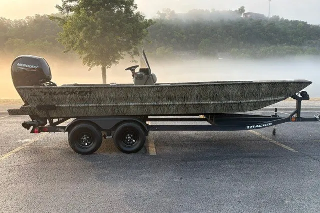 The Image of 2027 Tracker Grizzly 2072 CC boat on trailer, parked in misty outdoor setting. - 0