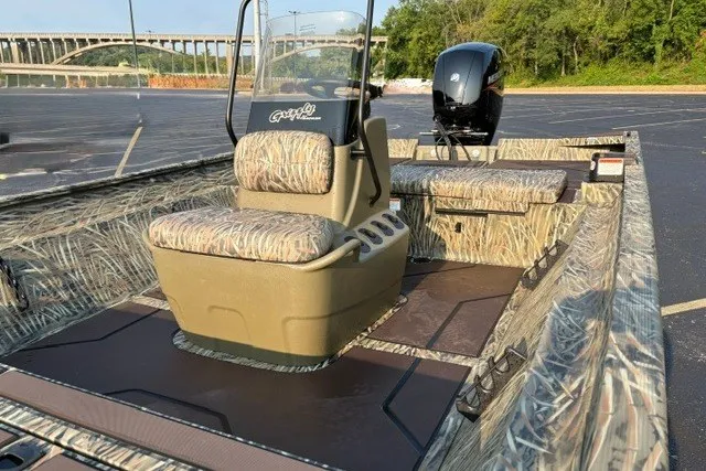 Slide: The Image of 2027 Tracker Grizzly 2072 CC boat with camouflage seating and powerful outboard motor. - 17
