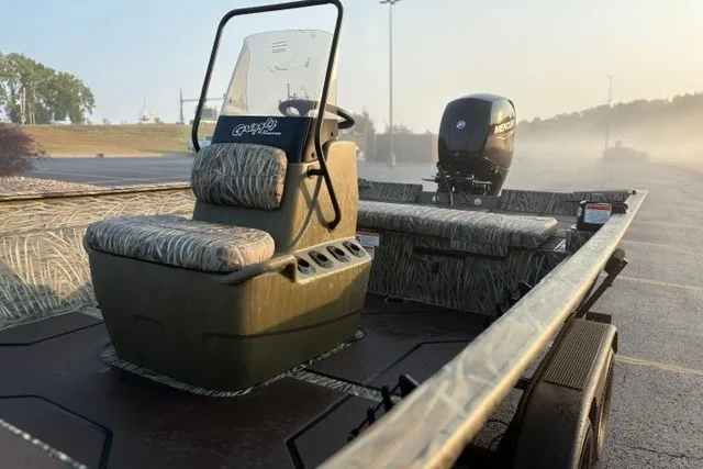 Slide: The Image of 2027 Tracker Grizzly 2072 CC boat with camo seats and Mercury outboard motor. - 14