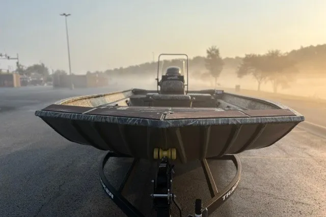 Slide: The Image of 2027 Tracker Grizzly 2072 CC boat on trailer in misty morning light. - 16