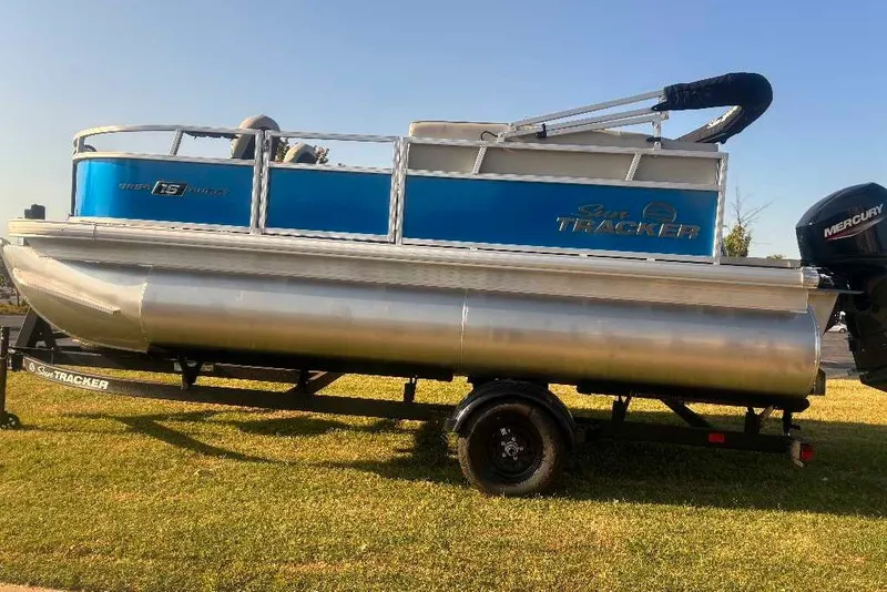 Slide: The Image of 2027 Sun Tracker Bass Buggy 16 XL Select pontoon boat on trailer, side view. - 16