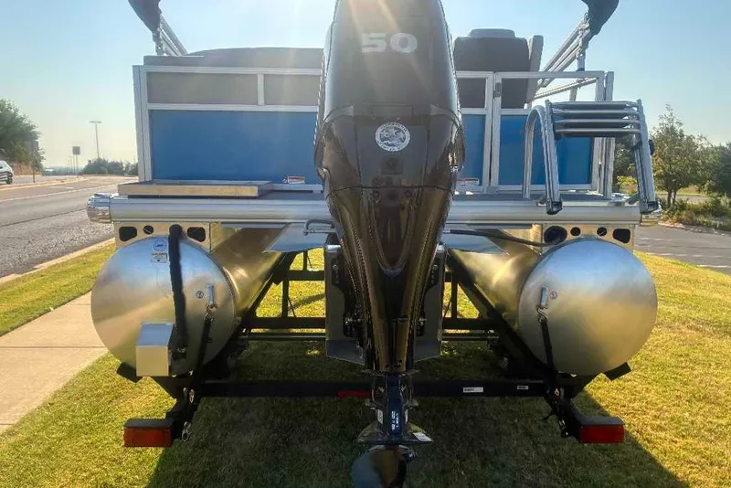 Slide: The Image of 2027 Sun Tracker Bass Buggy 16 XL Select pontoon boat with outboard motor on trailer. - 13