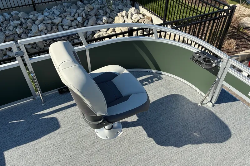 Slide: The Image of 2027 Sun Tracker Bass Buggy 16 XL Select boat seat with cup holder, outdoor setting. - 16