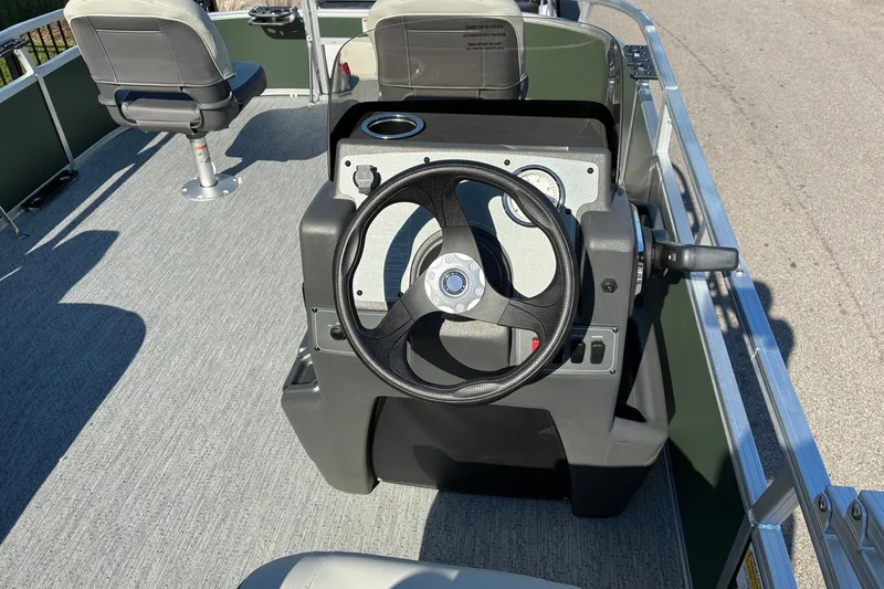 Slide: The Image of 2027 Sun Tracker Bass Buggy 16 XL Select boat interior with steering wheel and seating. - 13