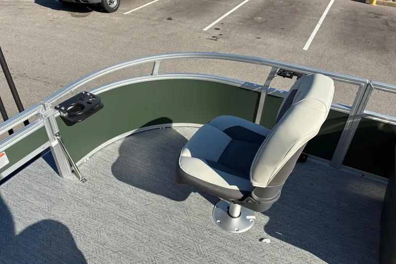 Slide: The Image of 2027 Sun Tracker Bass Buggy 16 XL Select boat seat with cup holder in parking lot. - 17