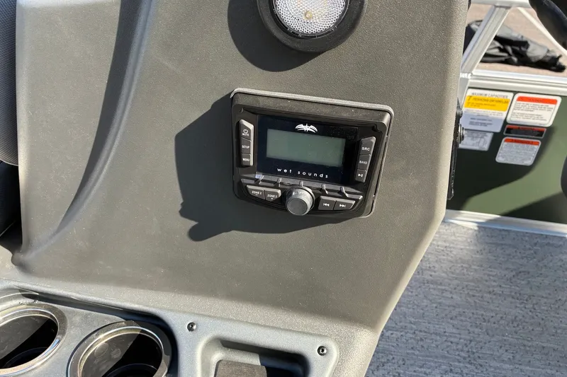 Slide: The Image of 2027 Sun Tracker Bass Buggy 16 XL Select dashboard with audio controls and cup holders. - 14