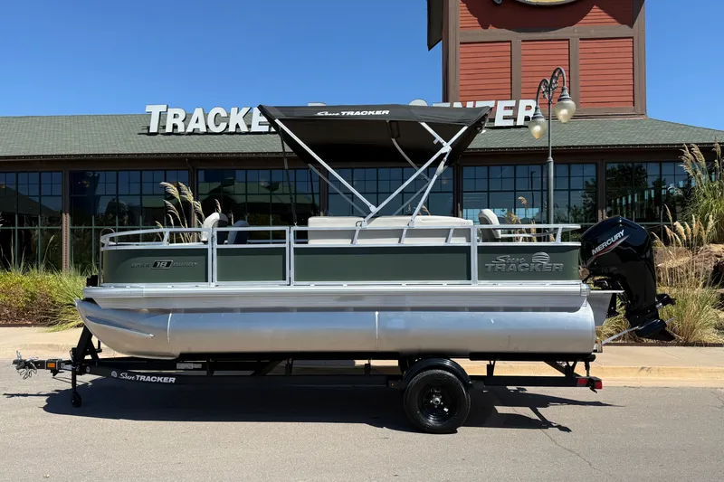The Image of 2027 Sun Tracker Bass Buggy 18 DLX pontoon boat displayed outdoors. - 0