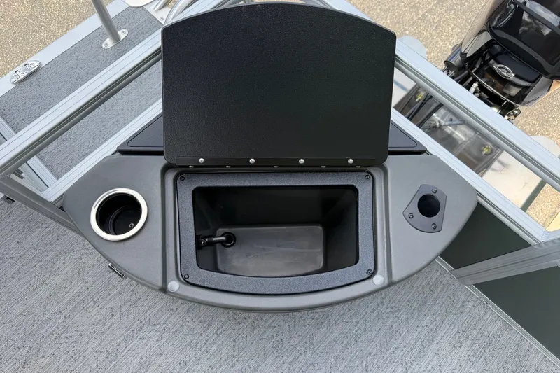 Slide: The Image of 2027 Sun Tracker Bass Buggy 18 DLX boat console with storage compartment and cup holder. - 24