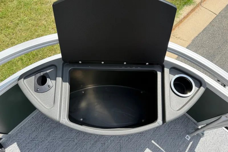 Slide: The Image of 2027 Sun Tracker Bass Buggy 18 DLX storage compartment with cup holders on deck. - 15