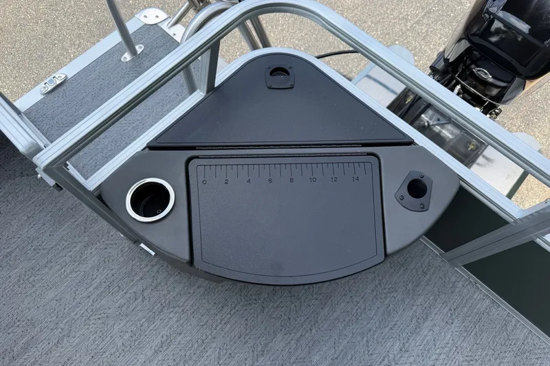Slide: The Image of 2027 Sun Tracker Bass Buggy 18 DLX boat deck with measuring board and cup holder. - 23