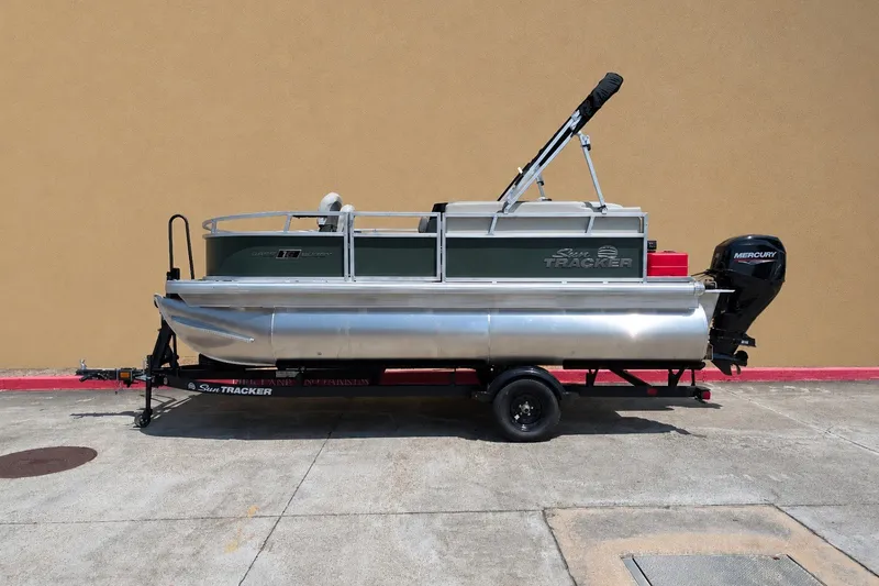 The Image of 2027 Sun Tracker Bass Buggy 16 XL Select pontoon boat on trailer, side view. - 0