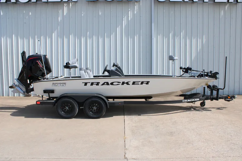The Image of 2027 Tracker Savage 215 boat on trailer, parked outside a metal building. - 0